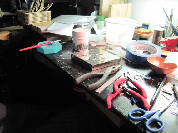 hammered silver rings on workbench